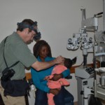 Dr. Erick Bothun examining a young child